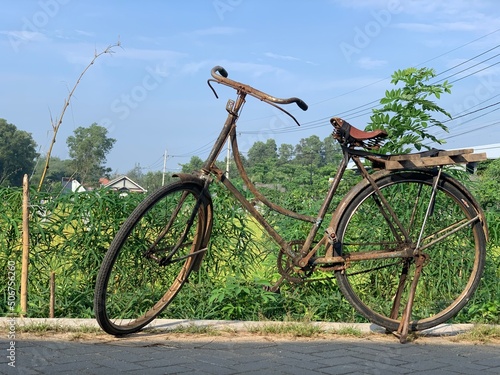Old bicycle on the roadside © Widyasto
