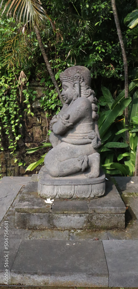 stone statue in a garden