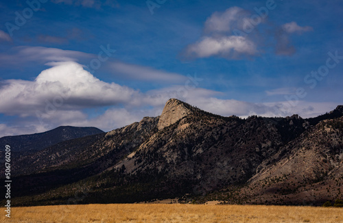 The Tooth of Time with fluffy clouds and a blue sky