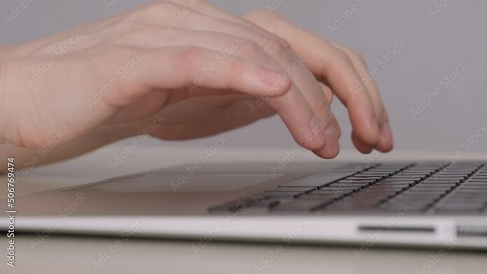 Close-up female hands typing on laptop, using touchpad. Woman freelancer writing letter at home office. Extreme close up fingers type text on keyboard. Close-up female hands typing on laptop, using touchpad. Woman freelancer writing letter at home office. Extreme close up fingers type text on keyboard.