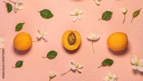 Fototapeta Naklejka Na Ścianę i Meble -  Delicious ripe sweet apricots on a pink background, smooth. selective focus. Apricots and sliced ones at the pastel pink background