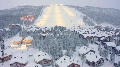 Drone aerial tilt up onto ski lodges, hotels, slopes, Levi, Finland ski resort