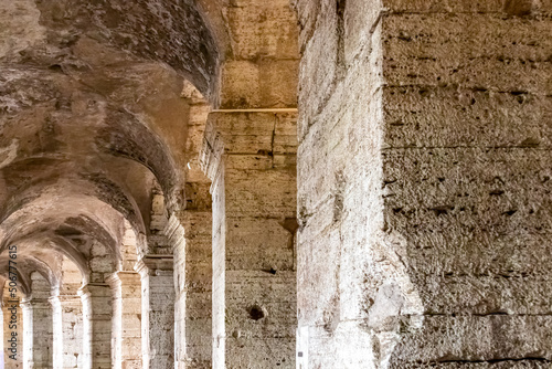 Massive columns of interior of the famous Colosseum of city of Rome  Lazio  Italy  Europe. UNESCO World Heritage Site. Corridor of Flavian Amphitheater the symbol of ancient Roma city in Roman Empire