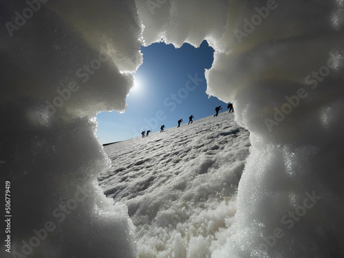 At the mountaineer festival, a group of people walking to the summit at 2998 meters takes place. photo