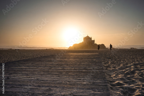 silhouette of a person walking on the beach ocean sunset  Capela do Senhor da Pedra porto portugal