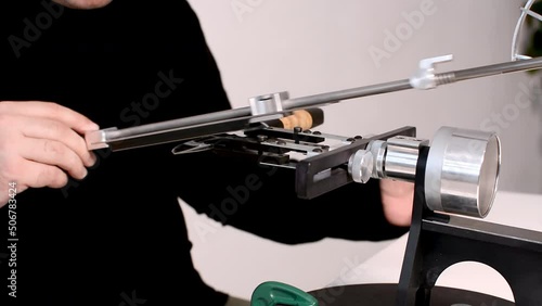 blogger conducts an online master class on sharpening knives on a hand machine.