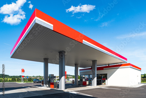 Gas station with clouds sky and sunlight
