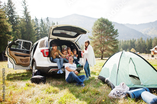 Wallpaper Mural Large family of four kids. Children in trunk. Traveling by car in the mountains, atmosphere concept. American spirit. Torontodigital.ca