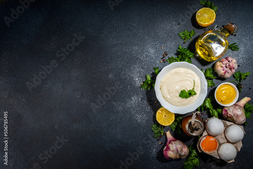 Homemade mayonnaise sauce. Bowl of mayonnaise with fresh ingredients top view copy space photo