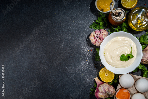 Homemade mayonnaise sauce. Bowl of mayonnaise with fresh ingredients top view copy space
