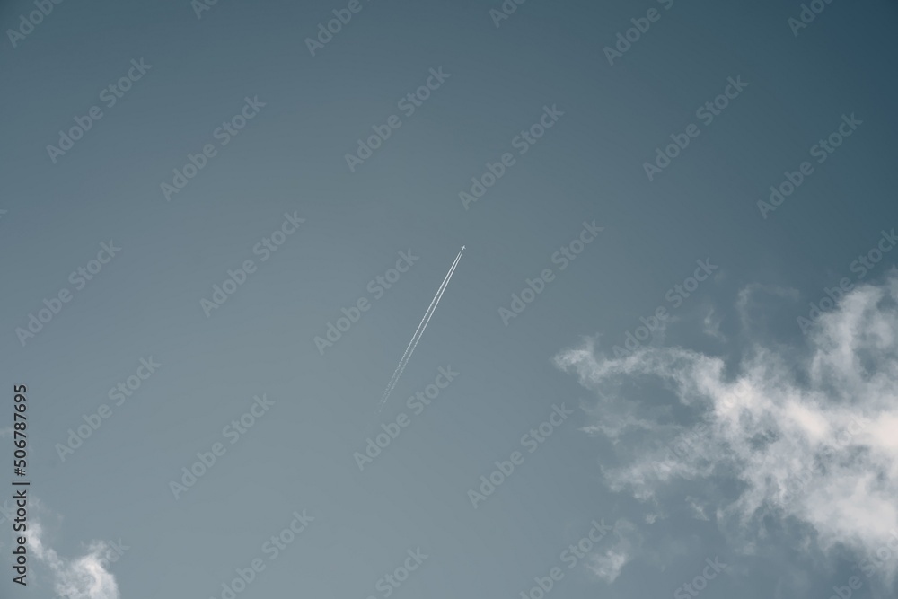 Aircraft in the sky with contrail. Diagonal vapor and condensation trail after modern jet high the in sky Aircraft in the sky with contrail. Diagonal vapor and condensation trail after modern jet high the in sky
