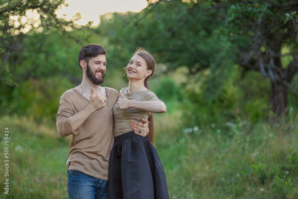 couple shows a gesture that everything is fine being in nature couple shows a gesture that everything is fine being in nature