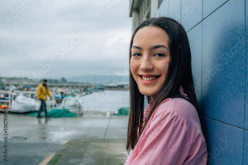 smiling young tourist woman in boat port