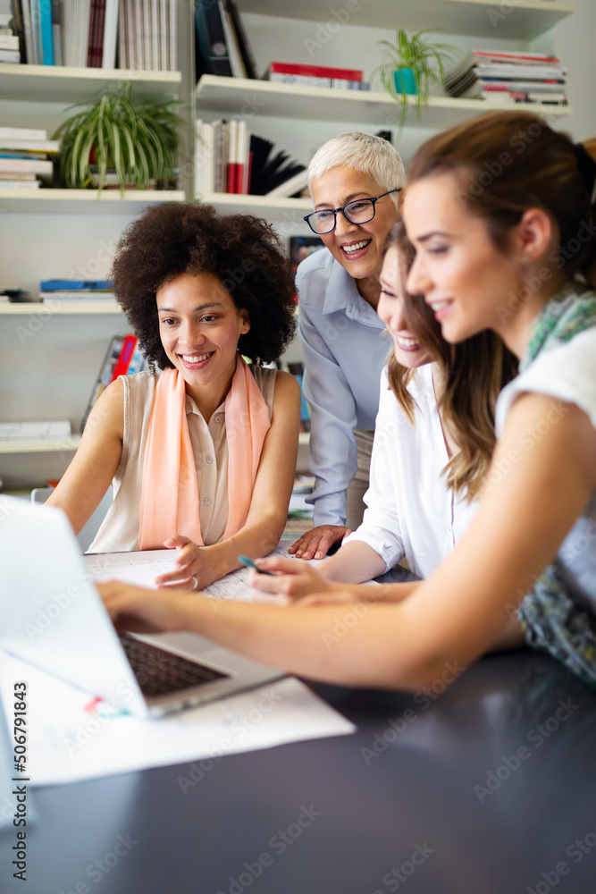 Group of happy business people working together on new project in corporate office. Group of happy business people working together on new project in corporate office.