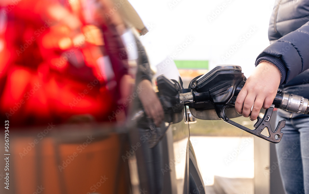 Refueling the car at a gas station fuel pump, car refueling on petrol