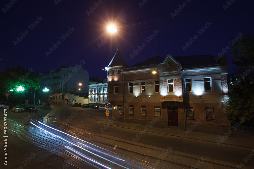 Moscow, Russia - July, 27 2014: Historical buildings in Moscow center at night. Mansion on Yauza boulevard. Tram rails and light traces on foreground.