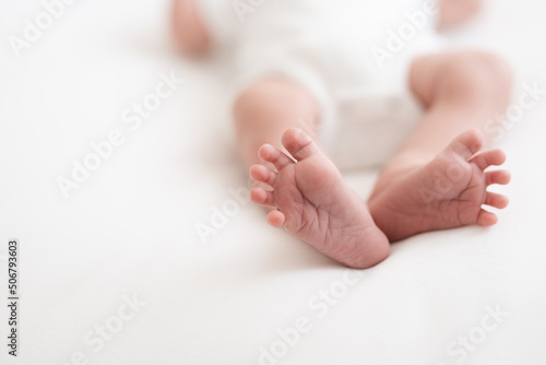 Fototapeta one week old cute newborn infant baby boy expressions tiny feet details