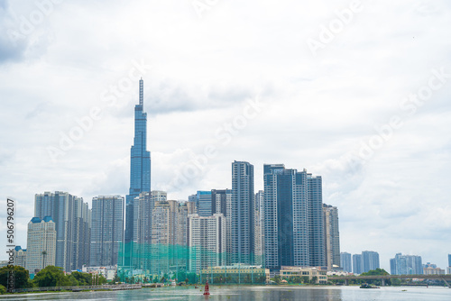 View at Landmark 81 - it is a super tall skyscraper and Saigon bridge with development buildings along Saigon river light smooth down photo