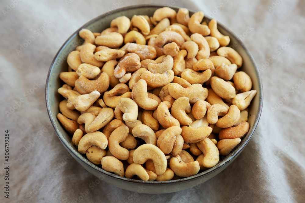 Homemade Roasted and Salted Cashews in a Bowl, side view. Close-up. Homemade Roasted and Salted Cashews in a Bowl, side view. Close-up.