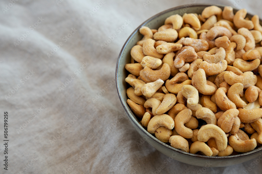 Homemade Roasted and Salted Cashews in a Bowl, side view. Copy space. Homemade Roasted and Salted Cashews in a Bowl, side view. Copy space.
