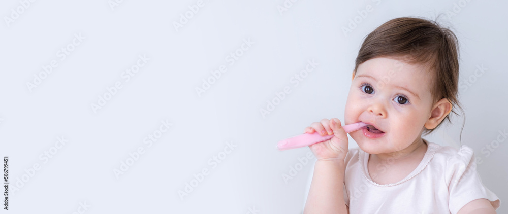 Banner copyspace baby girl eating blend mashed food sitting, on high chair, mother feeding child, hand with spoon for vegetable lunch, baby weaning, first solid food for young kid. Banner copyspace baby girl eating blend mashed food sitting, on high chair, mother feeding child, hand with spoon for vegetable lunch, baby weaning, first solid food for young kid.