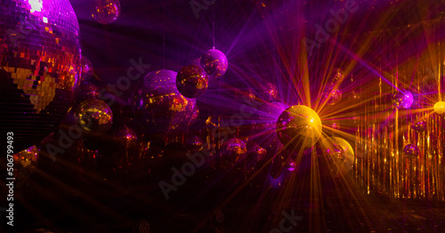  purple and yellow rays are reflected from mirrored disco balls