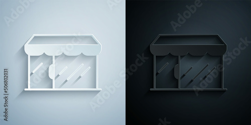 Paper cut Shopping building or market store icon isolated on grey and black background. Shop construction. Paper art style. Vector