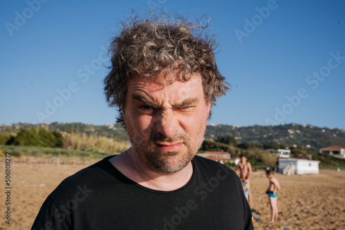 Father playing with children at the beach