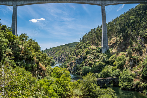 Highway bridge framing wild nature with various types of trees on the banks and Philippine bridge over the Zêzere river, Pedrogão Grnde PORTUGAL photo