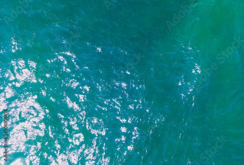 Aerial Drone photo. Beautiful turquoise green water background on summer sea beach. Relax and travel concept. Warm sunny weather.