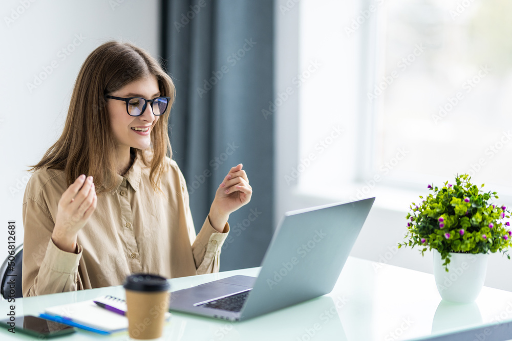 Business woman has video call with her remote team using laptop and camera Business woman has video call with her remote team using laptop and camera