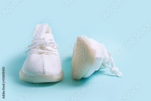 A pair of white sneakers on a blue background