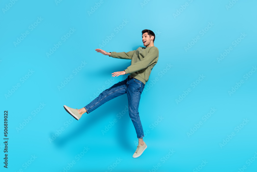 Full size photo of satisfied cheerful person falling jumping flight isolated on blue color background
