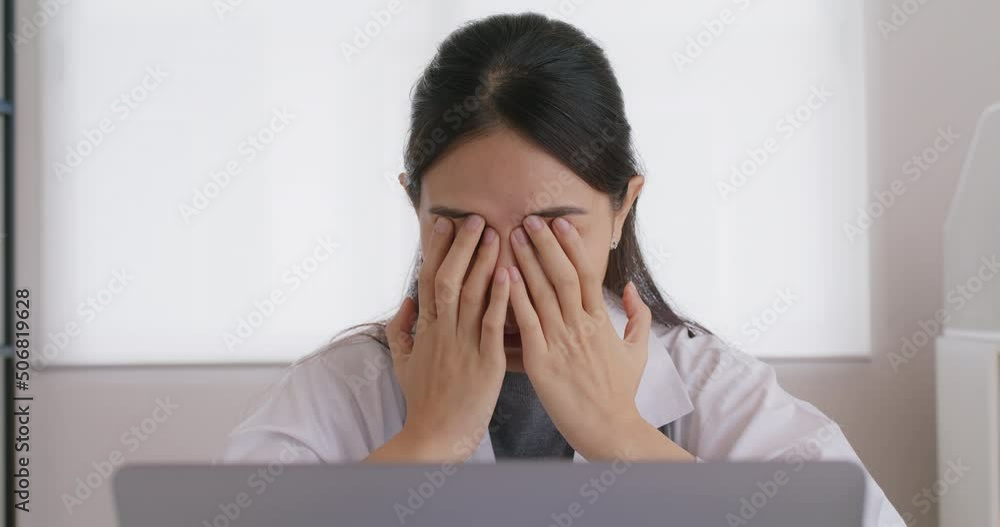 Young asia medical people sit work on desk at clinic office sad stiff neck stress tired long care online telehealth teleconsult telemedicine. Staff worker pain close face hands on eyes end finish job. Young asia medical people sit work on desk at clinic office sad stiff neck stress tired long care online telehealth teleconsult telemedicine. Staff worker pain close face hands on eyes end finish job.