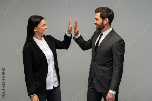 Business man and woman giving hi five and bump hand together for team work. Diversity business team concept