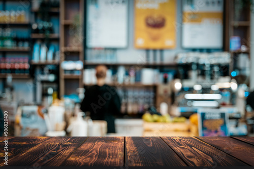 Coffee shop table background. Blurred interior cafe restaurant with wooden desk for product. Selected focus © uladzimirzuyeu