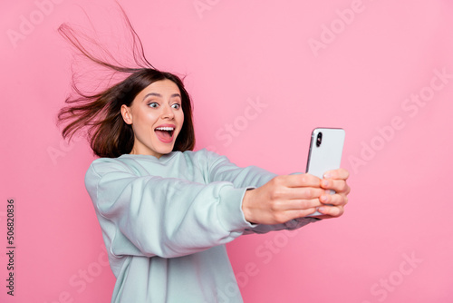 Profile side photo of young excited lady have fun make selfie vlogger isolated over pink color background
