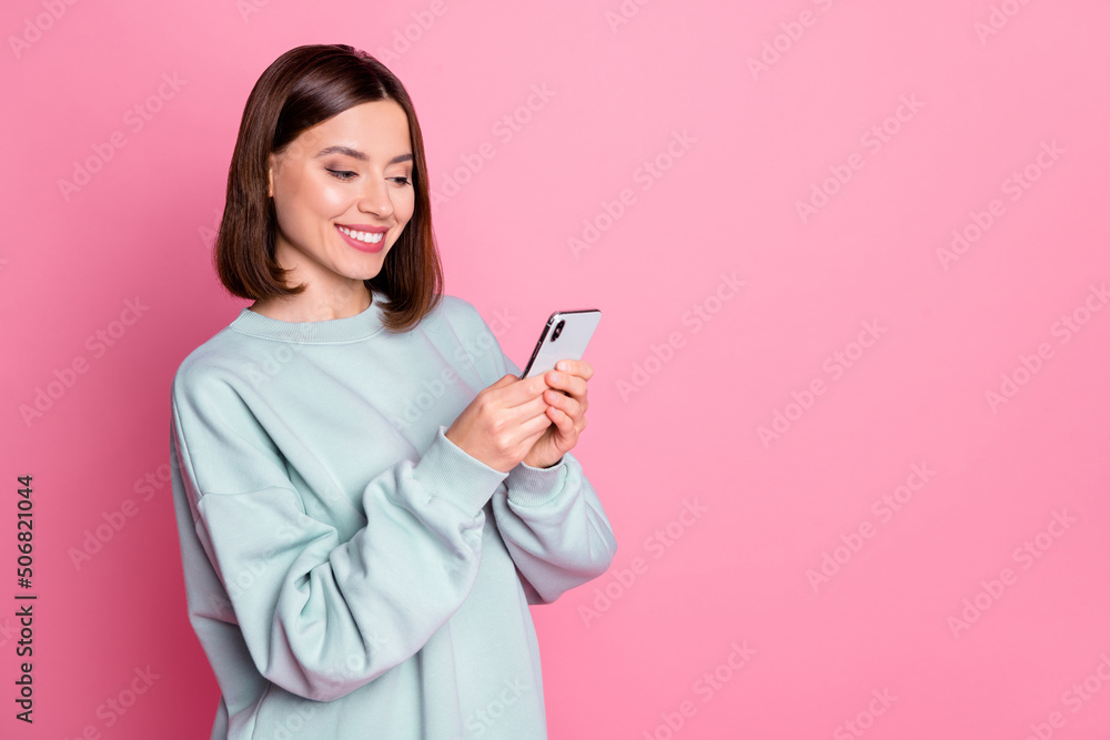 Profile side photo of young pretty woman use cellphone comment app download isolated over pink color background Profile side photo of young pretty woman use cellphone comment app download isolated over pink color background