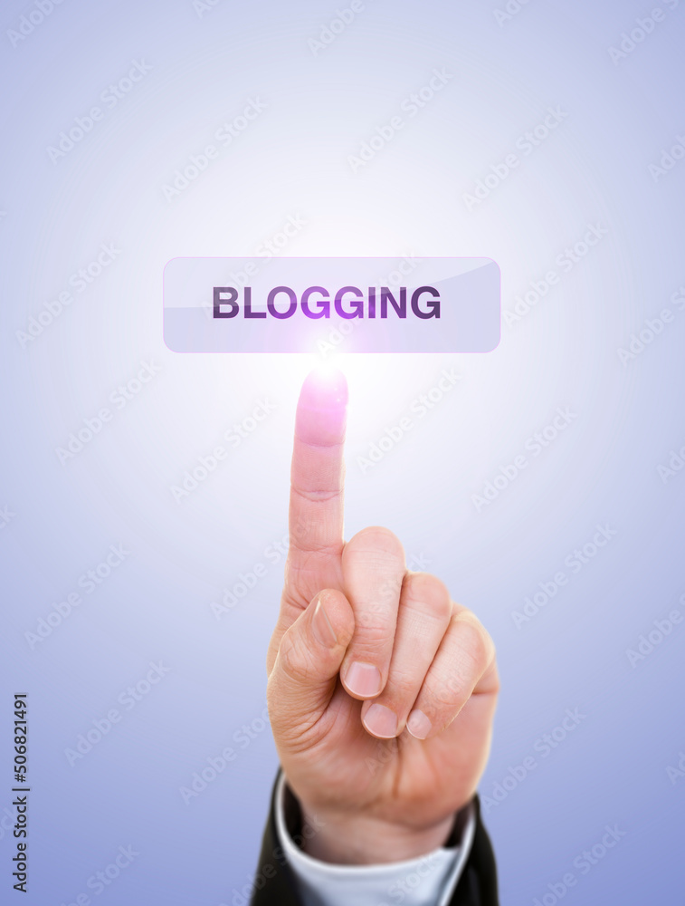 Businessman is Pushing On Blogging Button Against Blue Businessman is Pushing On Blogging Button Against Blue