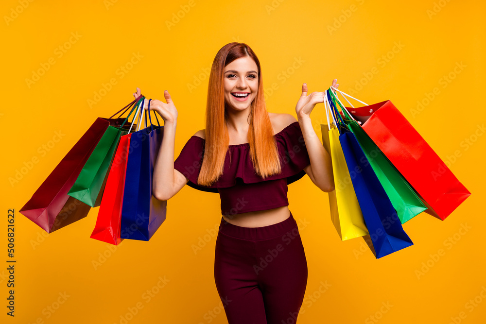 Photo of charming cute woman wear red outfit rising shopping bargains isolated yellow color background