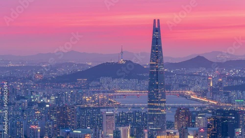 Zoom out,Time lapse 4k,The Sunset over the tops of Namsan and Lotte Tower in Seoul,South Korea.