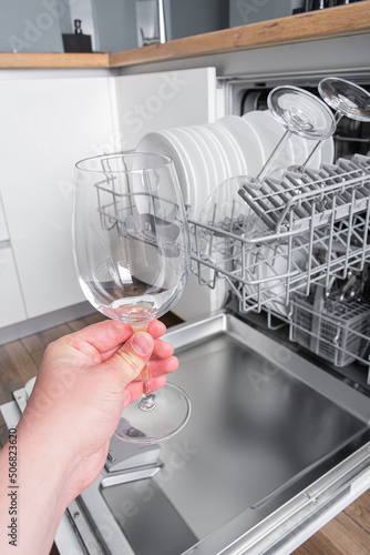 Open dishwasher with clean dishes in the kitchen