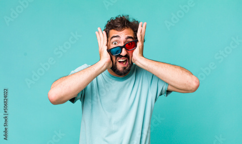 young adult hispanic crazy man with 3d cinema glasses photo