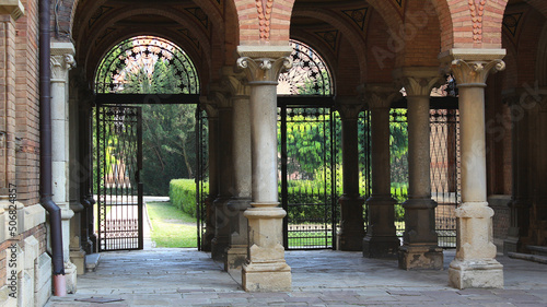 Colonnade And Forged Gate At Inner Courtyard Of Ancient Castle 