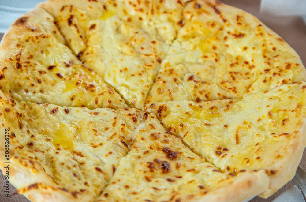Georgian cuisine Megrelian khachapuri on the table. Selective focus. Georgian cuisine Megrelian khachapuri on the table. Selective focus.
