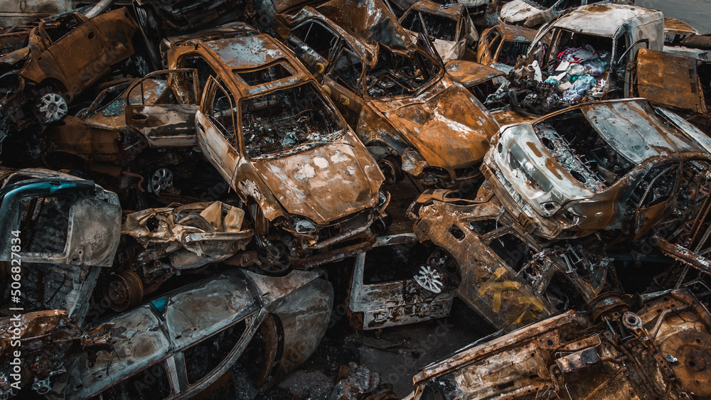 Irpin, Kyiv region, Ukraine - 19.05.2022 , a lot of burnt shelled cars in the parking lot, the consequences of the invasion of the Russian army in Ukraine. War in Ukraine. Drone photo