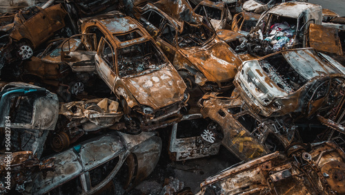 Obraz na płótnie Irpin, Kyiv region, Ukraine - 19.05.2022 , a lot of burnt shelled cars in the parking lot, the consequences of the invasion of the Russian army in Ukraine. War in Ukraine. Drone photo w salonie