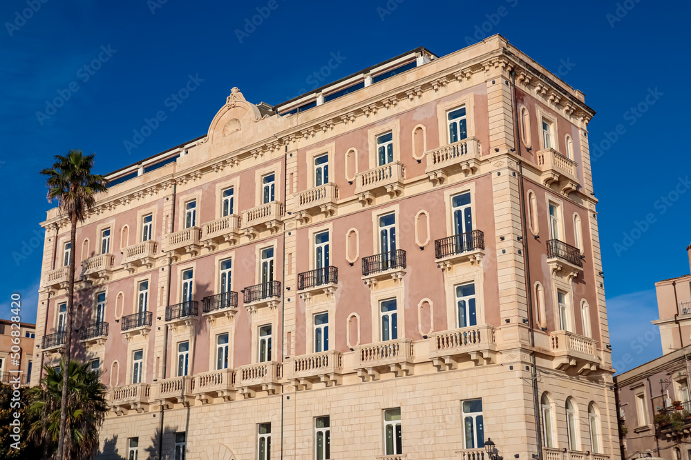 Close up view on a luxury hotel in the city center in Syracuse (Siracusa), Sicily, Italy, Europe. Historic residential city center of Piazza del Duomo, UNESCO World Heritage Site. Mediterranean flair