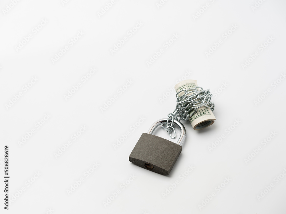 Currency roll locked with chain and padlock on the white background