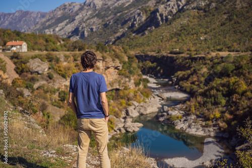 Montenegro. man tourist on the background of Clean clear turquoise water of river Moraca in green moraca canyon nature landscape. Travel around Montenegro concept